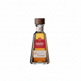 Front view of the 1800 Reposado tequila bottle with a unique shape and wooden cap