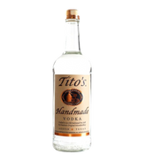 Front view of Tito's Handmade Vodka bottle with a clear body and brown label on a white background