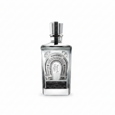 Front view of a clear glass bottle of Herradura Ultra tequila with a silver cap and decorative label.