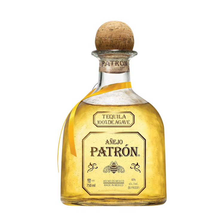 Detail shot of the Patrón Anejo tequila bottle with a cork stopper and gold label on a white background