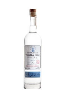 Front view of Tequila Ocho Plata in a clear glass bottle with a wooden cork.