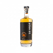Front view of De Nada Reposado Tequila bottle with a clear glass and metallic cap