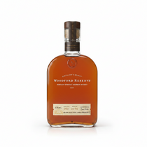 Front view of the Woodford Reserve bourbon bottle with a curved glass design and wooden cap.